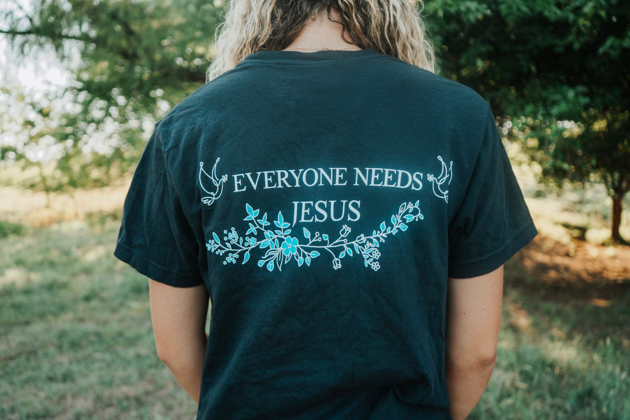 Flowered Light Blue Everyone Needs Jesus T-Shirt